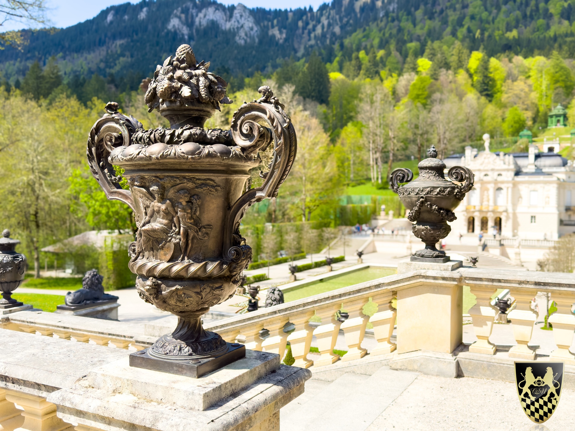 Decorative urns on a terrace with a scenic mountain backdrop.