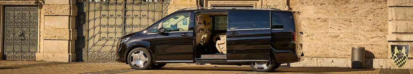 Black van parked with sliding door open, revealing beige interior.